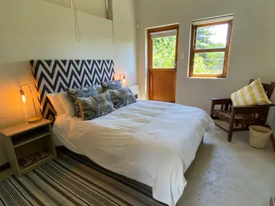 a bedroom with a large white bed and a window at Lovely Private room close to campus in Stellenbosch