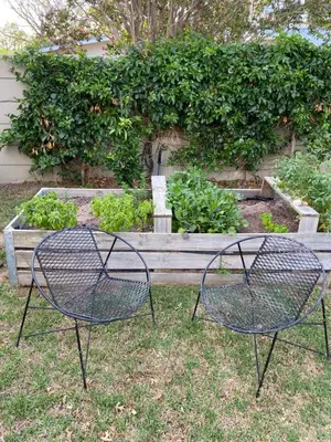 two metal chairs in front of a bench at Lovely Private room close to campus in Stellenbosch