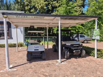 a golf cart under a pavilion with a golf at Riverside Glass Cabin Franschhoek in Franschhoek