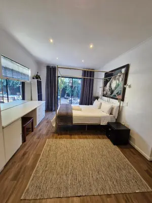 a bedroom with a bed and a large window at Regent Casa's - Cape Towns Blouberg Area - Where 20 people can stay in Cape Town