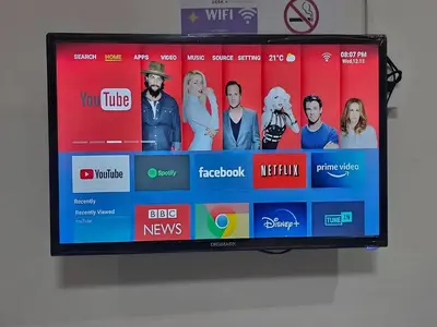 a television screen with a group of people on it at Goshen Lodge Spencer in Cape Town