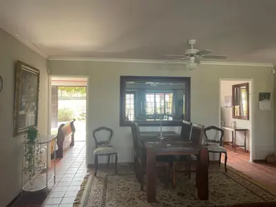 a dining room with a table and chairs at Lakeview Cottage: Rural Retreat in Pampoenkraal