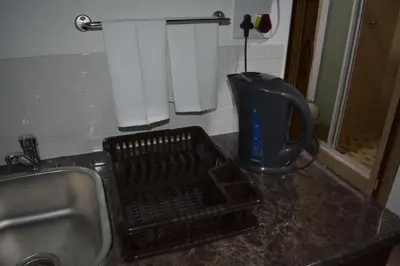 a kitchen counter with a sink and a dish drying at 105 on Sarel Cilliers in Strand
