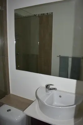 a white bathroom with a sink and a mirror at 105 on Sarel Cilliers in Strand