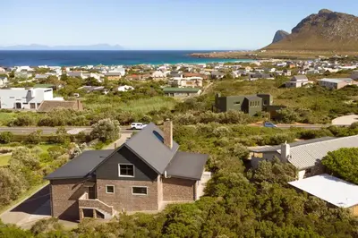 an aerial view of a small town with a house at Secure, luxurious with lovely views in Pringle Bay