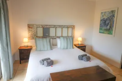 a bedroom with a large white bed with two lamps at 31 on Witzenberg, Tulbagh in Wolseley