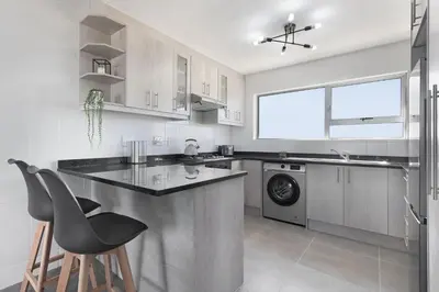 a kitchen with a counter and a dishwasher at Ocean View 503 in Bloubergstrand