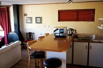a kitchen with a table with a coffee maker on it at The View Upstairs - A spacious apartment with a view in Durbanville