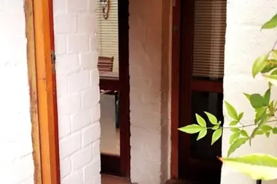a door leading into a room with a mirror at The View Upstairs - A spacious apartment with a view in Durbanville