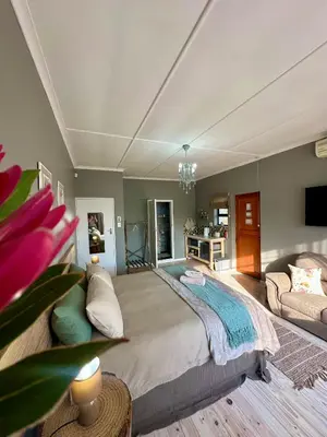 a bedroom with a large bed and a couch at Mia Amore in Caledon