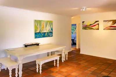 a dining room with a table and two benches at The Mountainview Family Retreat in Hermanus