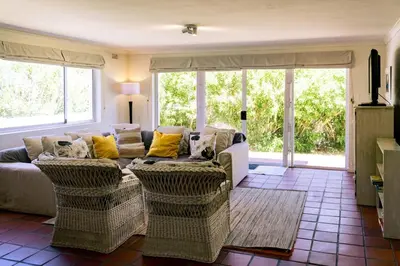 a living room with a couch and two chairs at The Mountainview Family Retreat in Hermanus