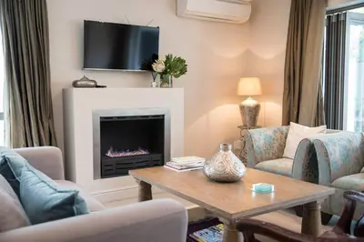 a living room with a fireplace with a tv at 13 La Gratitude Luxury Apartment-with backup power for loadshedding in Stellenbosch
