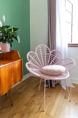 a pink chair and a table in a room at Boho Chic Apartment Stellenbosch in Stellenbosch
