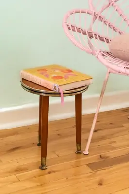 a stool next to a chair and a table at Boho Chic Apartment Stellenbosch in Stellenbosch