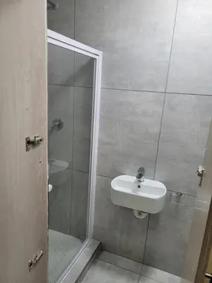 a bathroom with a sink and a shower at MIRAJO Guest House in Cape Town