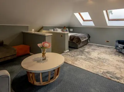 a living room with a table and a bed at Faraway Estate in Villiersdorp