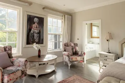 a bedroom with a bed and a table and chairs at Faraway Estate in Villiersdorp