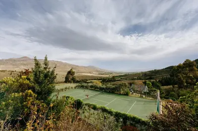 a tennis court in the middle of a field at Faraway Estate in Villiersdorp