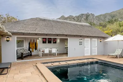a villa with a swimming pool and a house at Faraway Estate in Villiersdorp