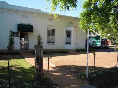 a white building with a sign in front of it at Avenues Guest House in Stellenbosch