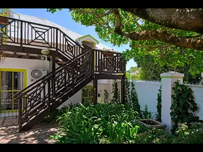 a wooden staircase leading up to a house at Ashbourne Boutique Guest House in Franschhoek