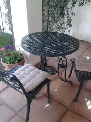 a black table and chairs sitting on a patio at Sunny Lane in Franschhoek