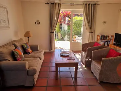 a living room with two couches and a coffee table at Sunny Lane in Franschhoek