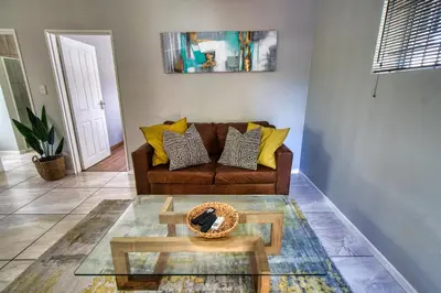 a living room with a couch and a coffee table at Magnificent Apartment in Cape Town