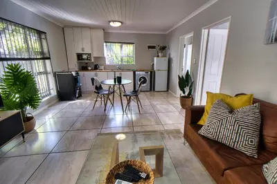 a living room with a couch and a table at Magnificent Apartment in Cape Town