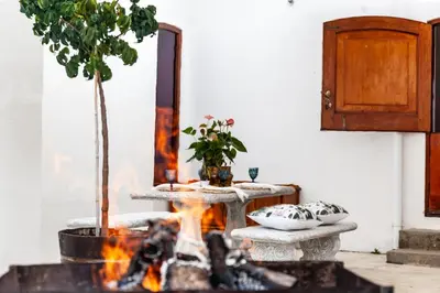 a fire pit in a living room with a mirror at Ayama Wine Farm - Manor House in Wellington