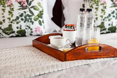 a wooden tray with a cup and a bottle of alcohol at Ayama Wine Farm - Manor House in Wellington