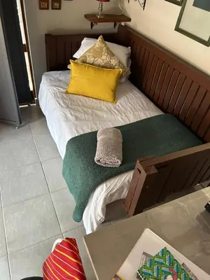 a bed with two pillows on it in a room at Mabel View in Cape Town