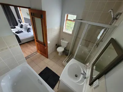 a bathroom with a sink and a shower and a toilet at Elegantie Apartment Protea 5 Lovell Avenue in Stellenbosch