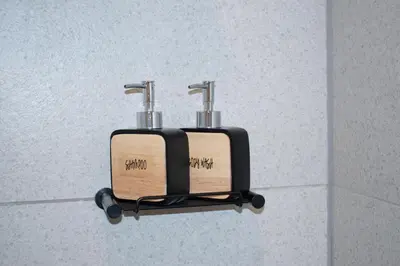 a soap dispenser on a wall in a bathroom at 101 Bridgewater Apartment in Cape Town