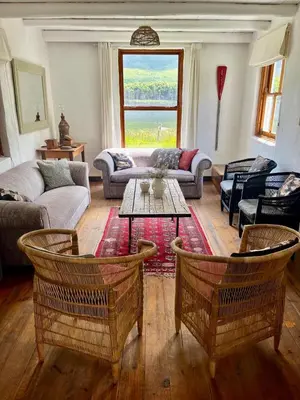 a living room with a couch and a table at Tranquility in Hermanus