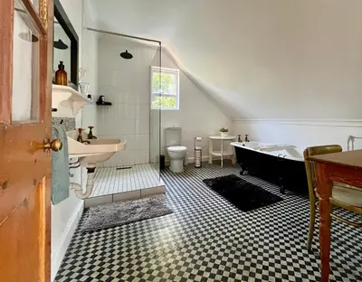 a bathroom with a sink and a tub and a toilet at Tranquility in Hermanus