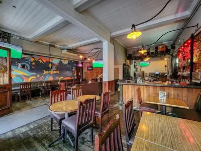 a restaurant with tables and chairs and a bar at Obs Loft Apartments Observatory in Cape Town