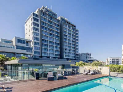 a hotel with a swimming pool and a building at Ocean View Penthouse in Cape Town