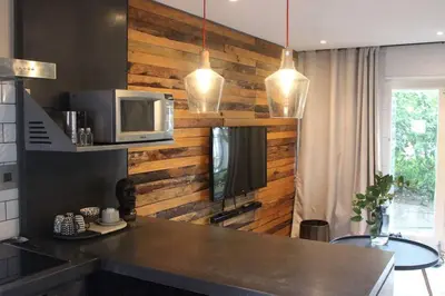 a kitchen with a counter with a microwave and a tv at Well Appointed Apartment by ARPA Hospitalities in Stellenbosch