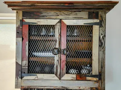 an old wooden cabinet with a glass door at Suikerbos in Pringle in Pringle Bay