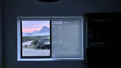a window in a room with a view of the ocean at Suikerbos in Pringle in Pringle Bay
