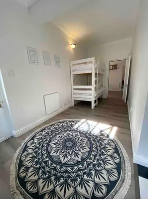 a room with a black and white rug on the floor at Auret Street Garden Cottage in Paarl