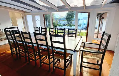 a dining room with a white table and chairs at Grotto Cottage in Hermanus