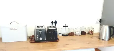 a counter with a toaster and other items on it at Grotto Cottage in Hermanus
