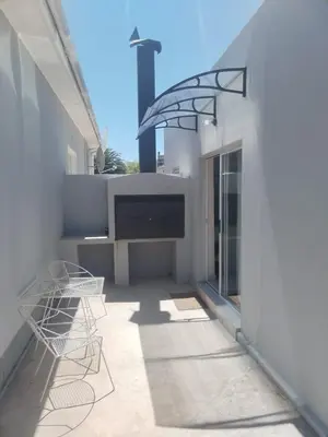 a patio with chairs and a table on a building at Harmonie Self Catering in Wolseley