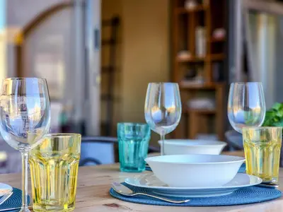 a table with wine glasses and a bowl on it at Family-Friendly Home with Ample Space in Cape Town