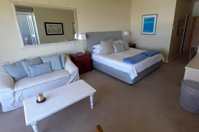 a living room with a couch and a bed at 305B Bayview Breathe in Hermanus