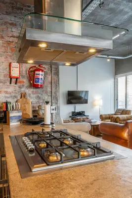 a kitchen with a stove top in a living room at Sunset-Loft in Cape Town