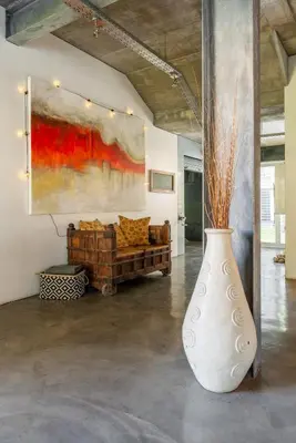 a large white vase in a room with a couch at Sunset-Loft in Cape Town